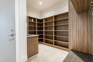 Mud,Room,With,Brown,Cabinets,Empty,Shelves,Coat,Hooks,And